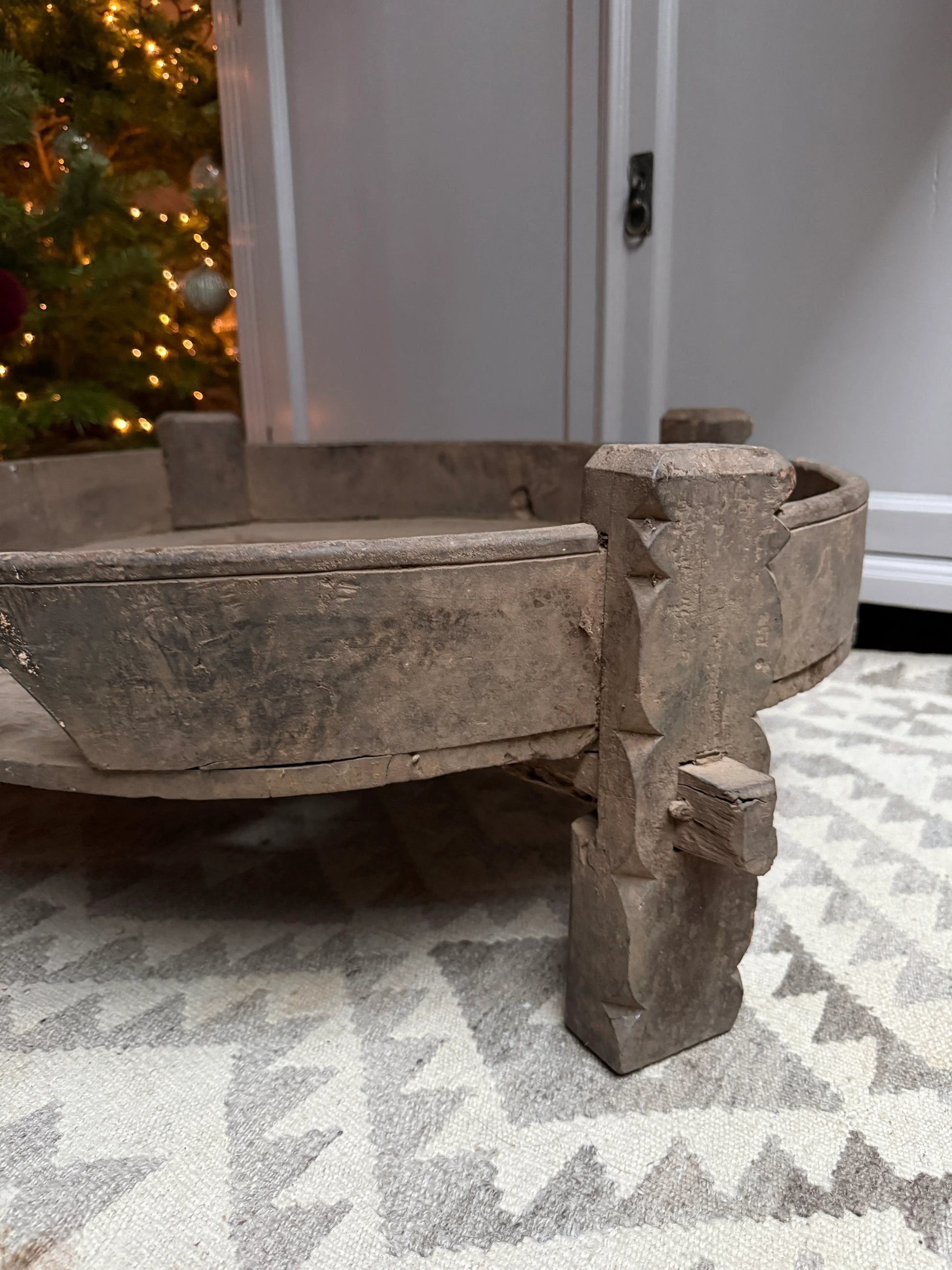 Handgemaakte houten chakkitafel op tapijt, sfeervol decor bij My Sober Home, landelijk interieur