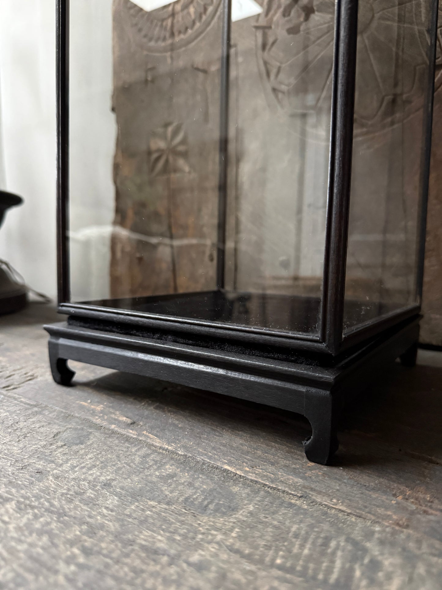 Zwarte metalen vitrinekast op houten tafel, sober interieur accessoire My Sober Home.