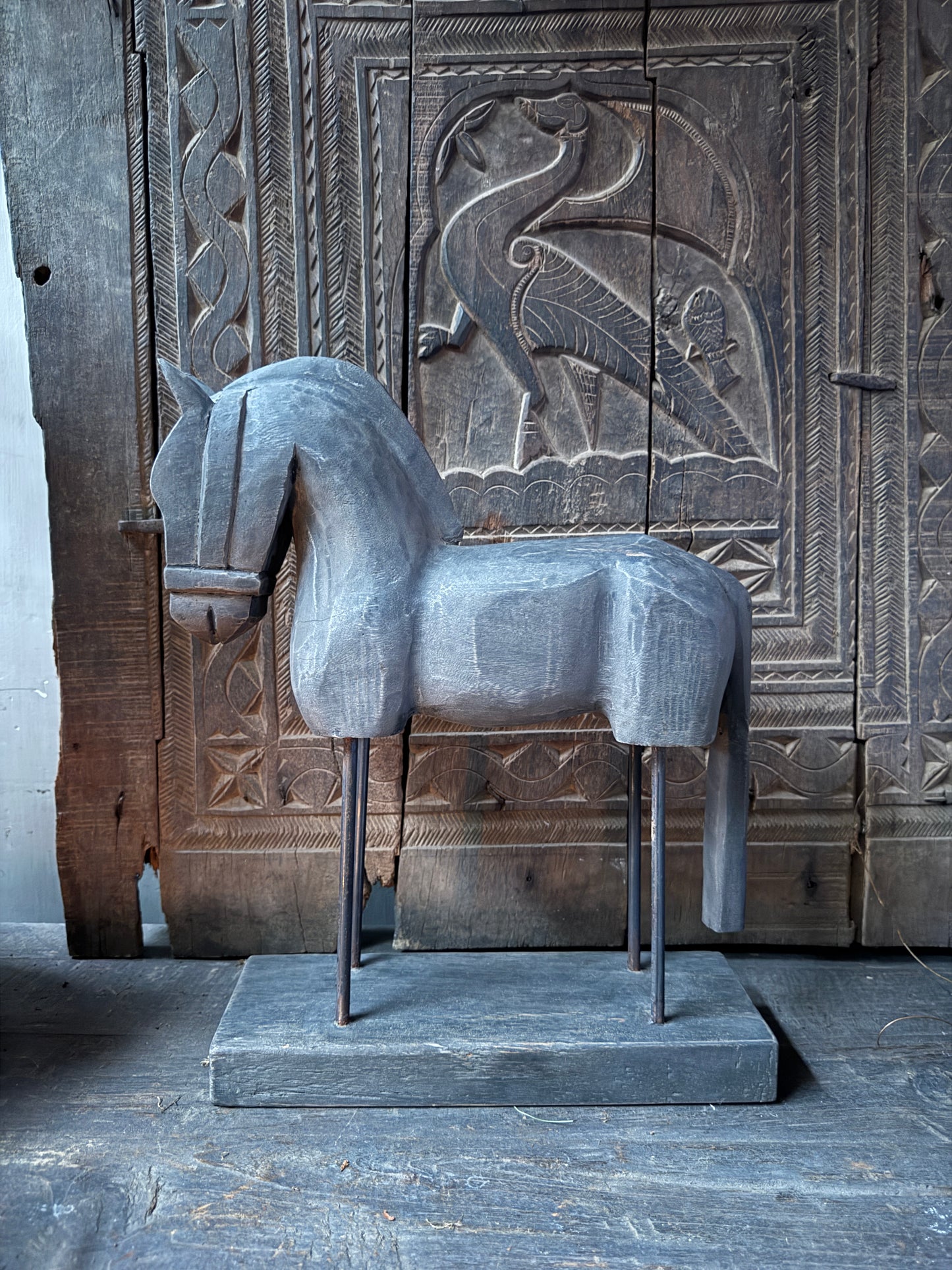 Wooden horse on stand
